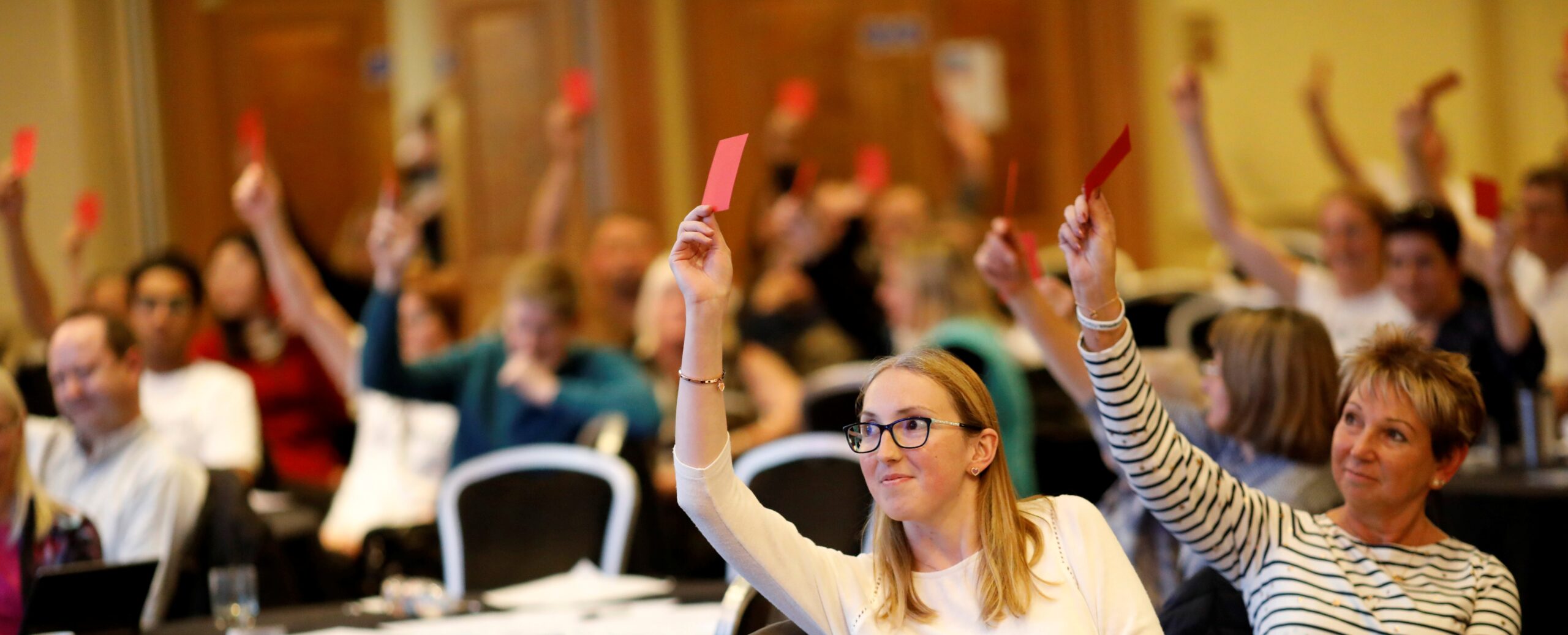 Nystagmus Network members hold up their voting cards.