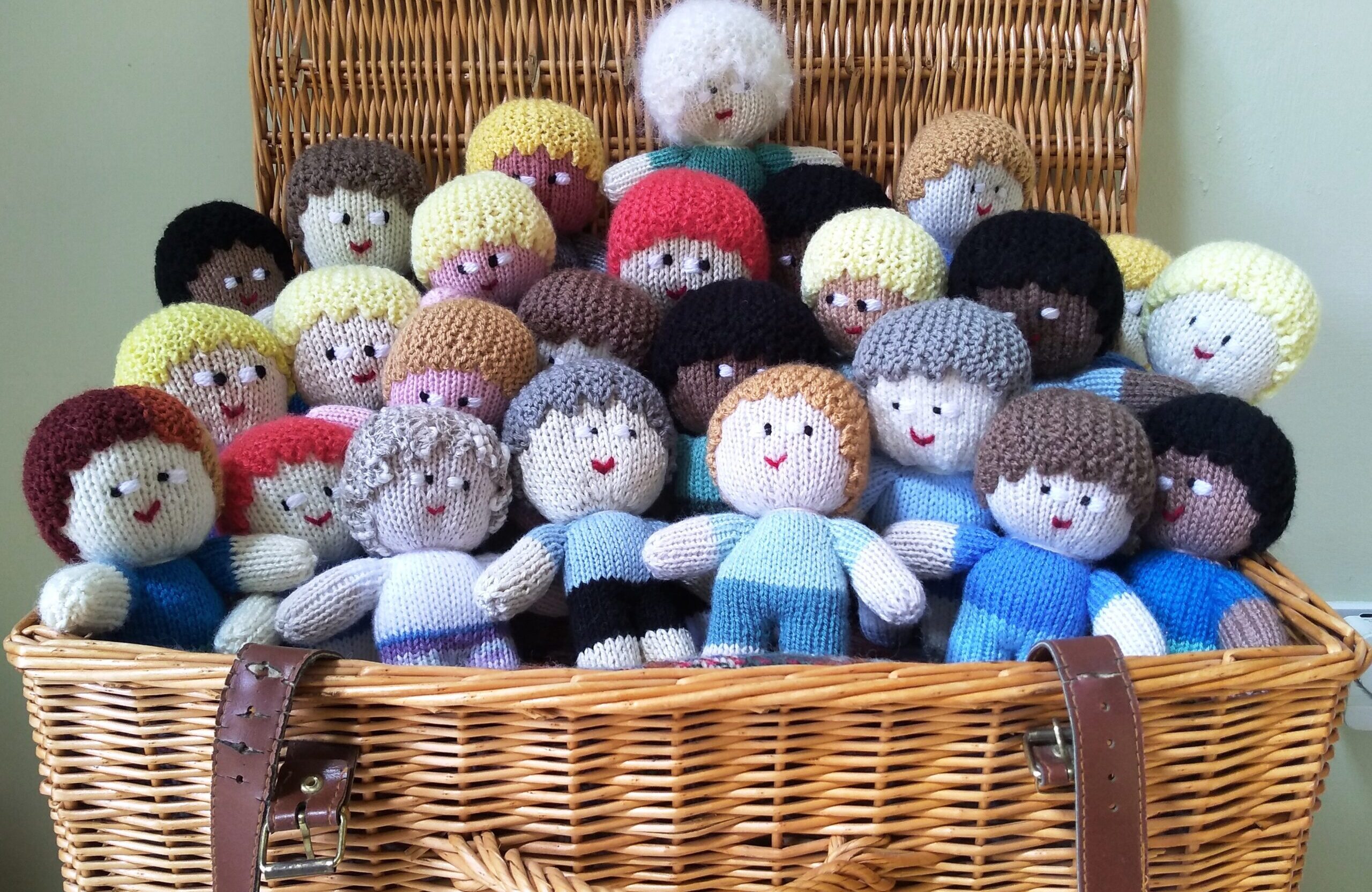 A picnic hamper full of knitted mascots.
