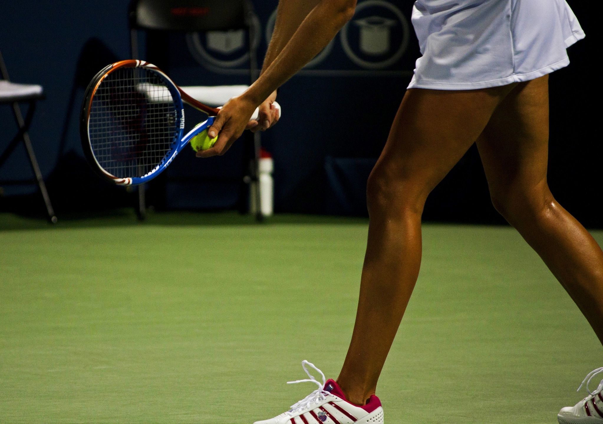 A tennis player about to serve the ball