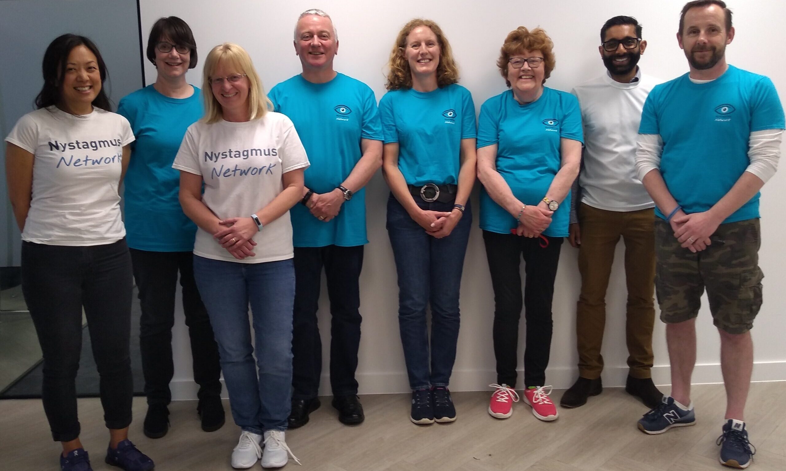 Nystagmus Network trustees smile for the camera, wearing their charity T-shirts.
