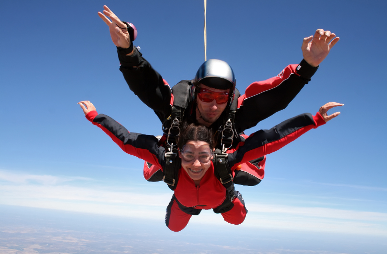 Two people taking part in a tandem skydive.