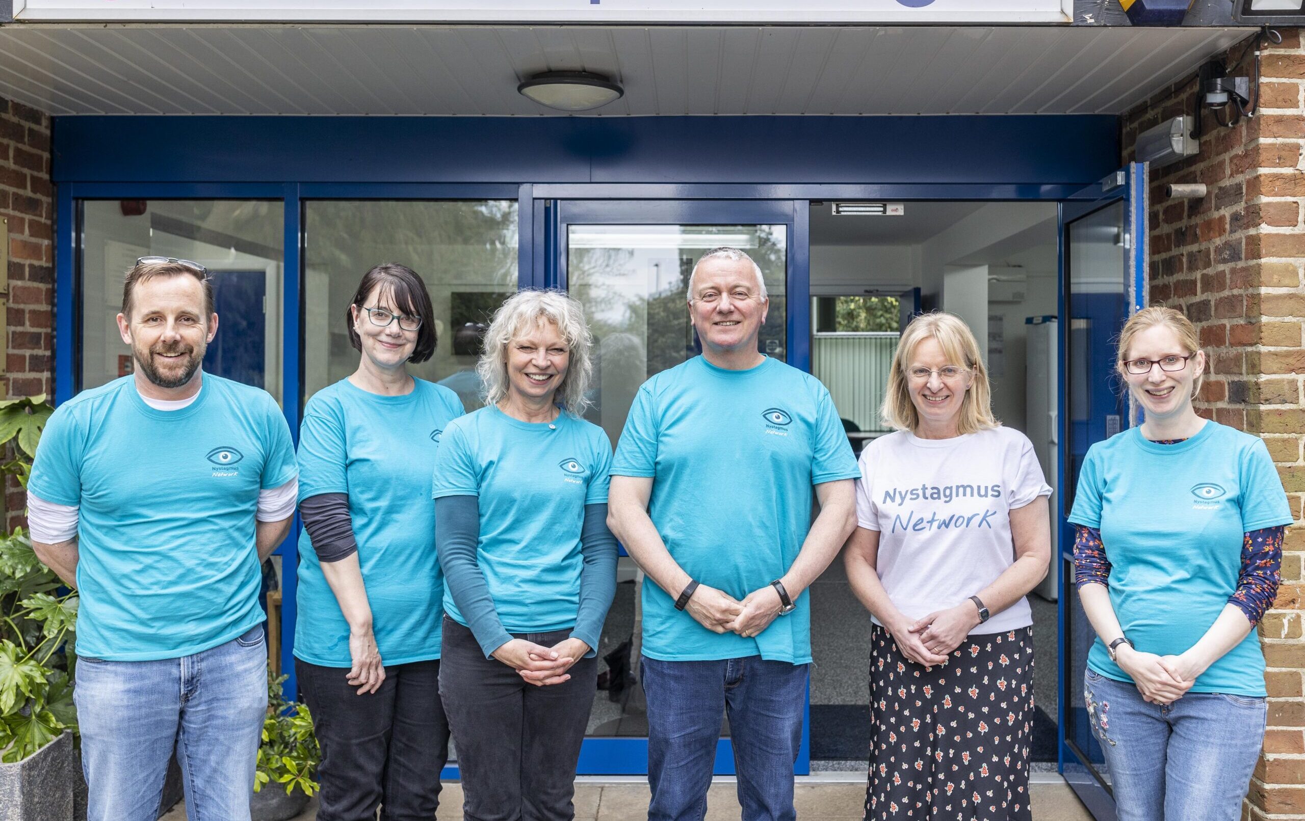 Nystagmus Network staff and trustees stand together.