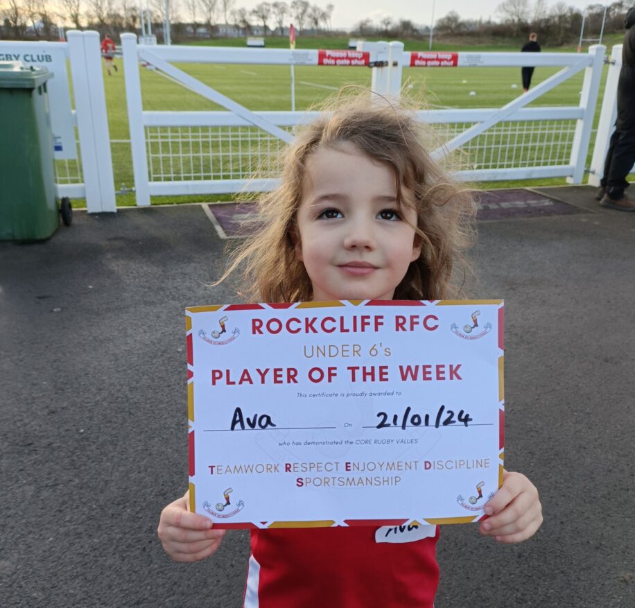Ava holds her 'player of the week' certificate for the camera.