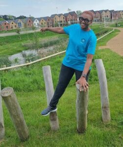 Onyeka in a park near her home. She is wearing her Nystagmus Network T-shirt.