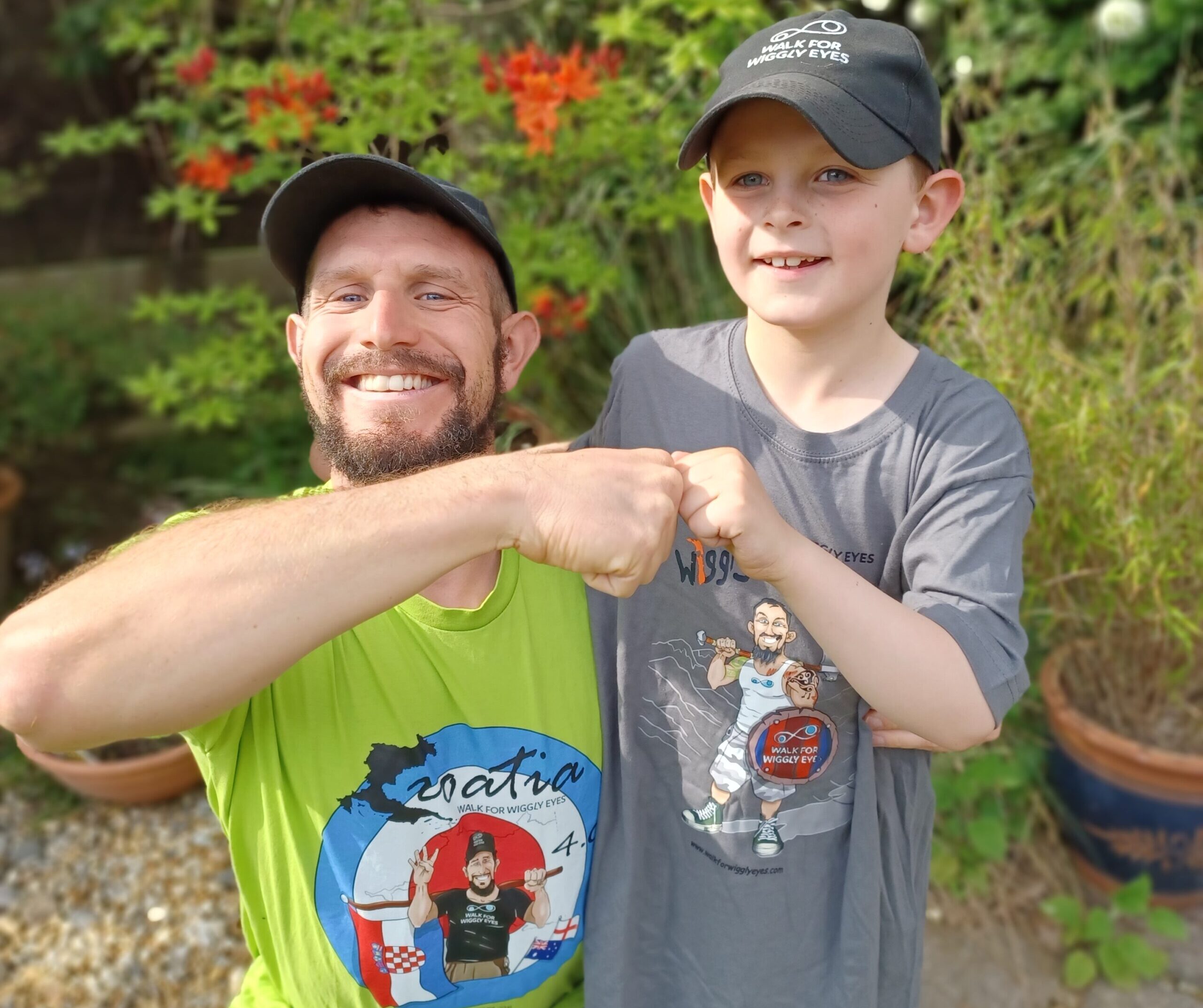 Mike and his nephew, both wearing WWE T-shirts, fist bump for the camera.