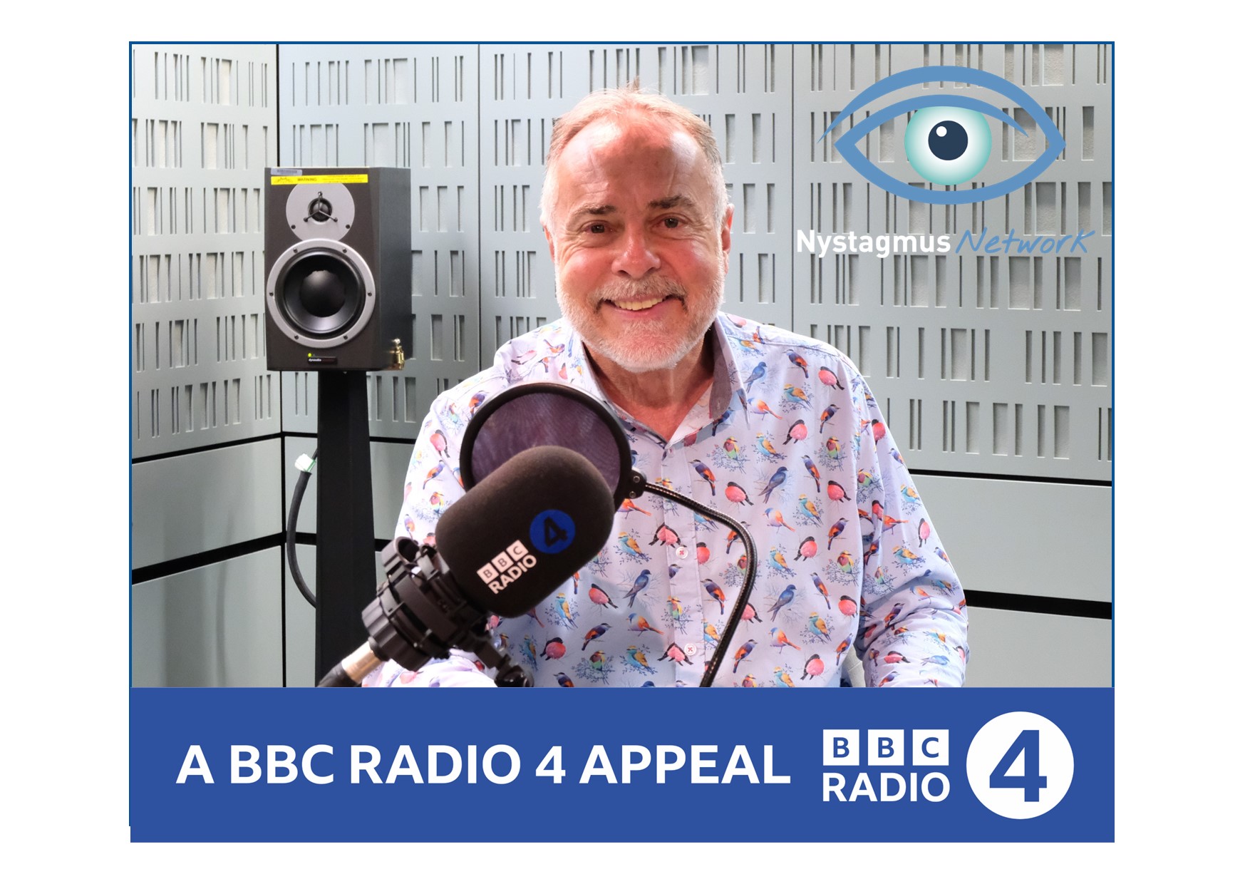 Gerard sits in a BBC radio recording studio, wearing a colourful shirt and smiling.