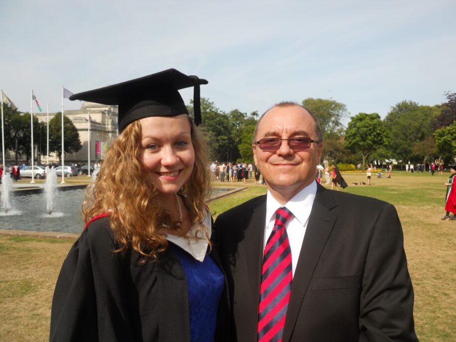 Claire and her Father, Richard are smiling for the camera. Claire is wearing a mortarboard at her graduation.