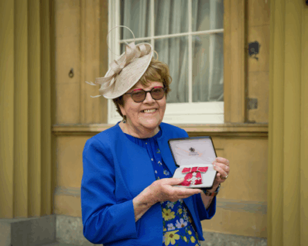 Vivien Jones holding her MBE.