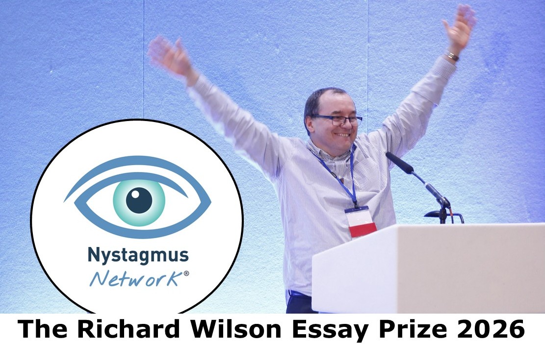 Richard stands at a podium with his arms held aloft in celebration.