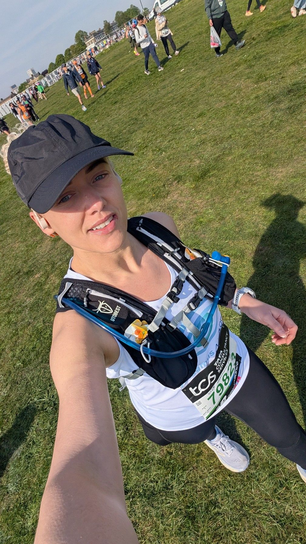 Kim wearing her Nystagmus Network running vest and a black cap.
