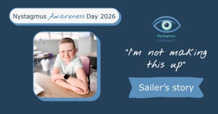 Sailer sits at a desk and smiles for the camera.